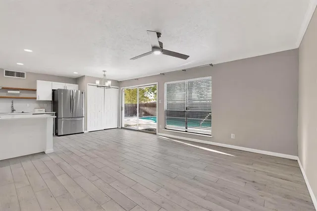 a kitchen with stainless steel appliances a refrigerator and a stove top oven