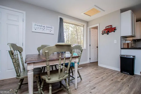 a view of a dining room with furniture and wooden floor