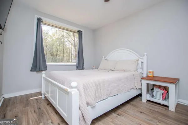 a bedroom with a bed and a ceiling fan