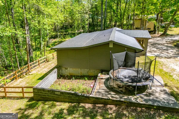 a backyard of a house with barbeque oven