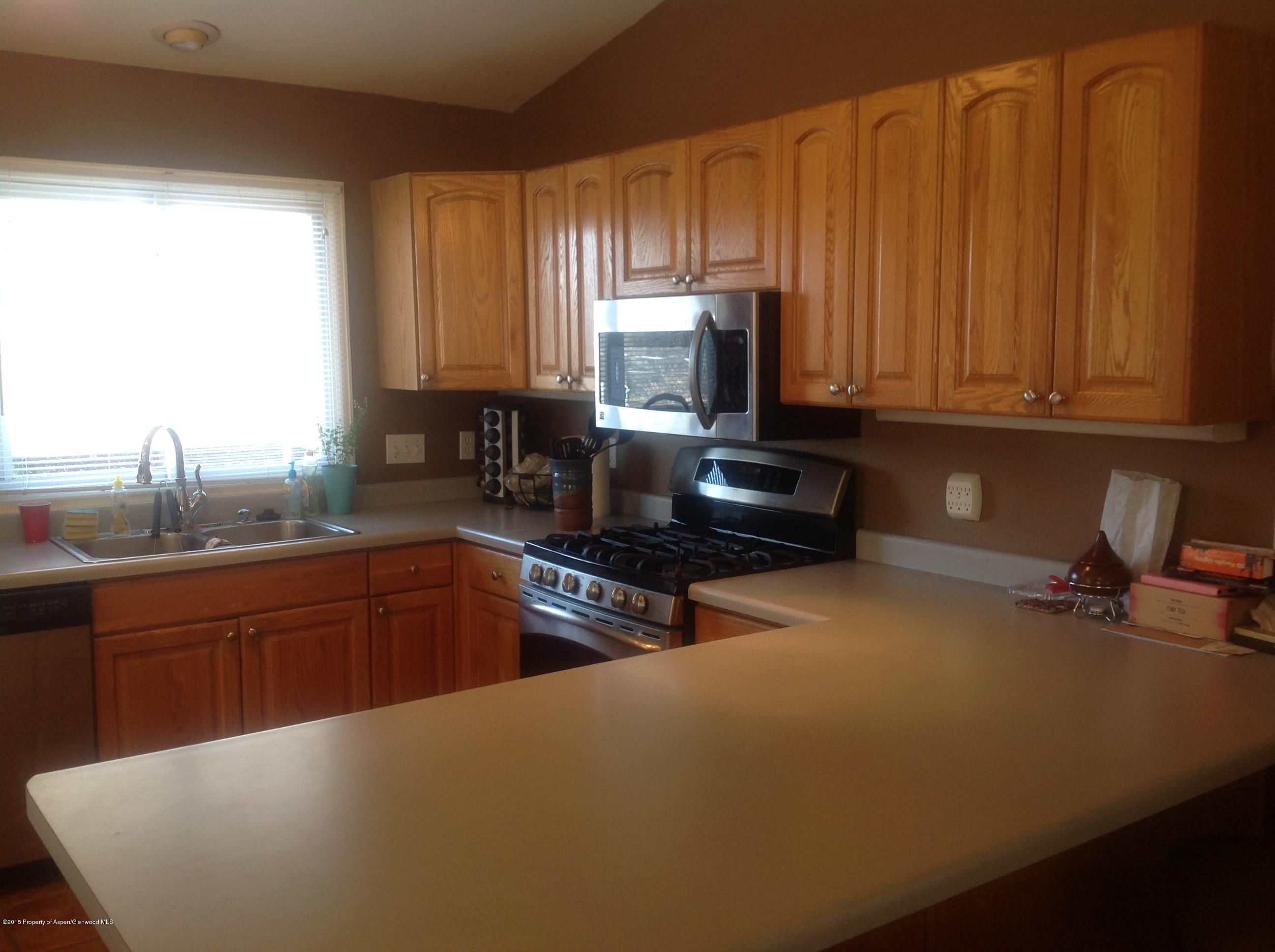 801 Whiteriver Avenue Rifle, CO 81650 - Photo 3 of 10 a kitchen with a sink a stove and cabinets