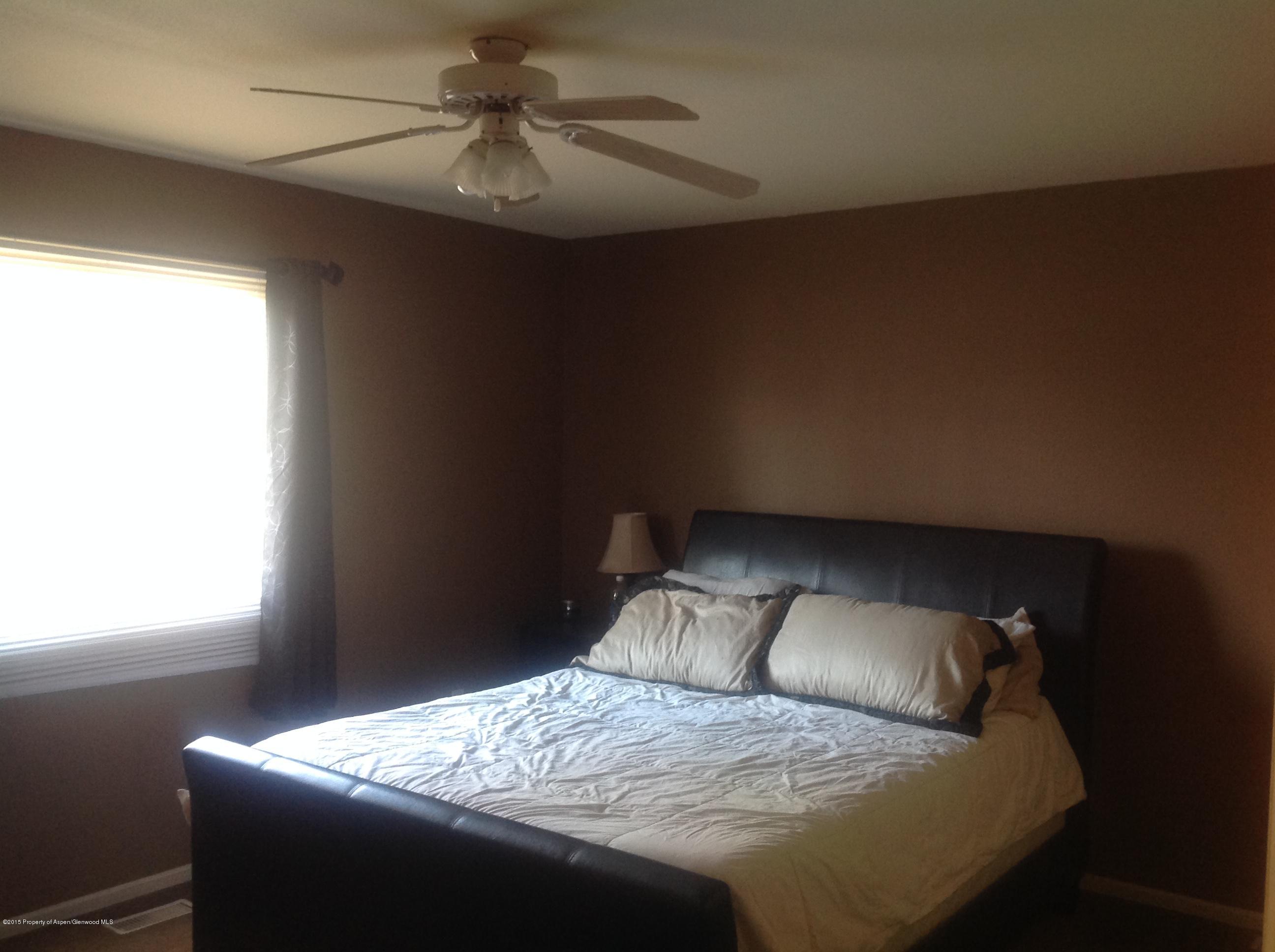 801 Whiteriver Avenue Rifle, CO 81650 - Photo 7 of 10 a bed sitting in a bedroom next to a window