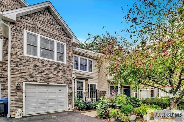 a front view of a house with a tree