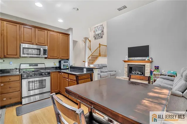 a kitchen with stainless steel appliances a stove a sink and a microwave