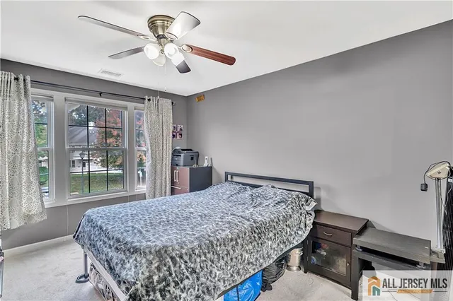 a bedroom with a bed and dresser