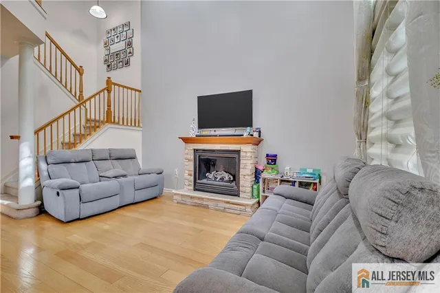 a living room with furniture a fireplace and a flat screen tv