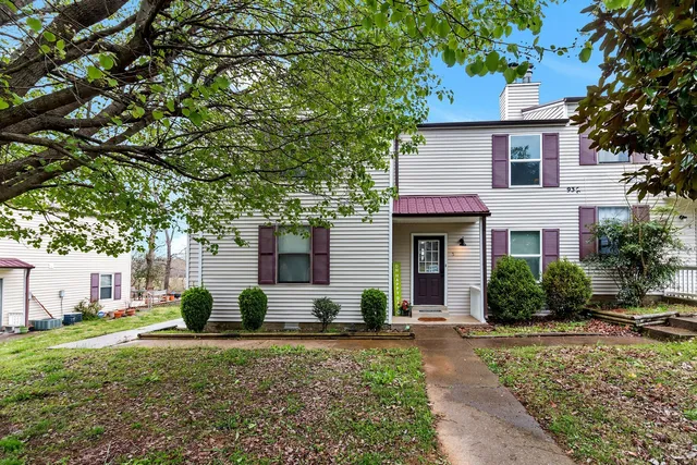 a view of a house with backyard and a tree