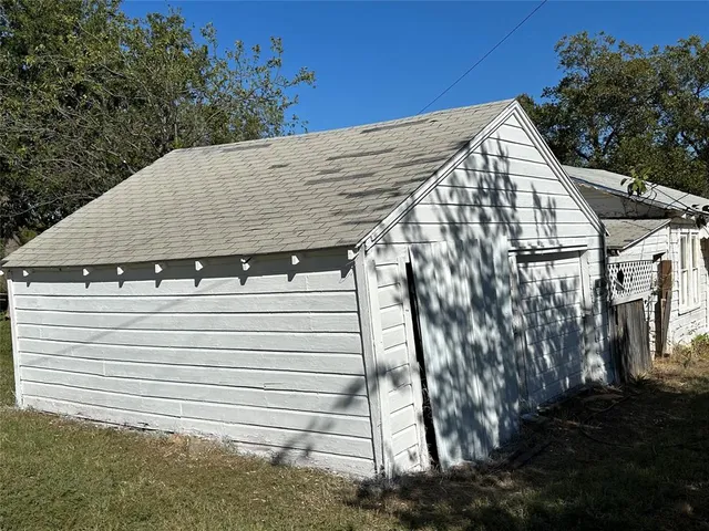 a view of a white house with a small space