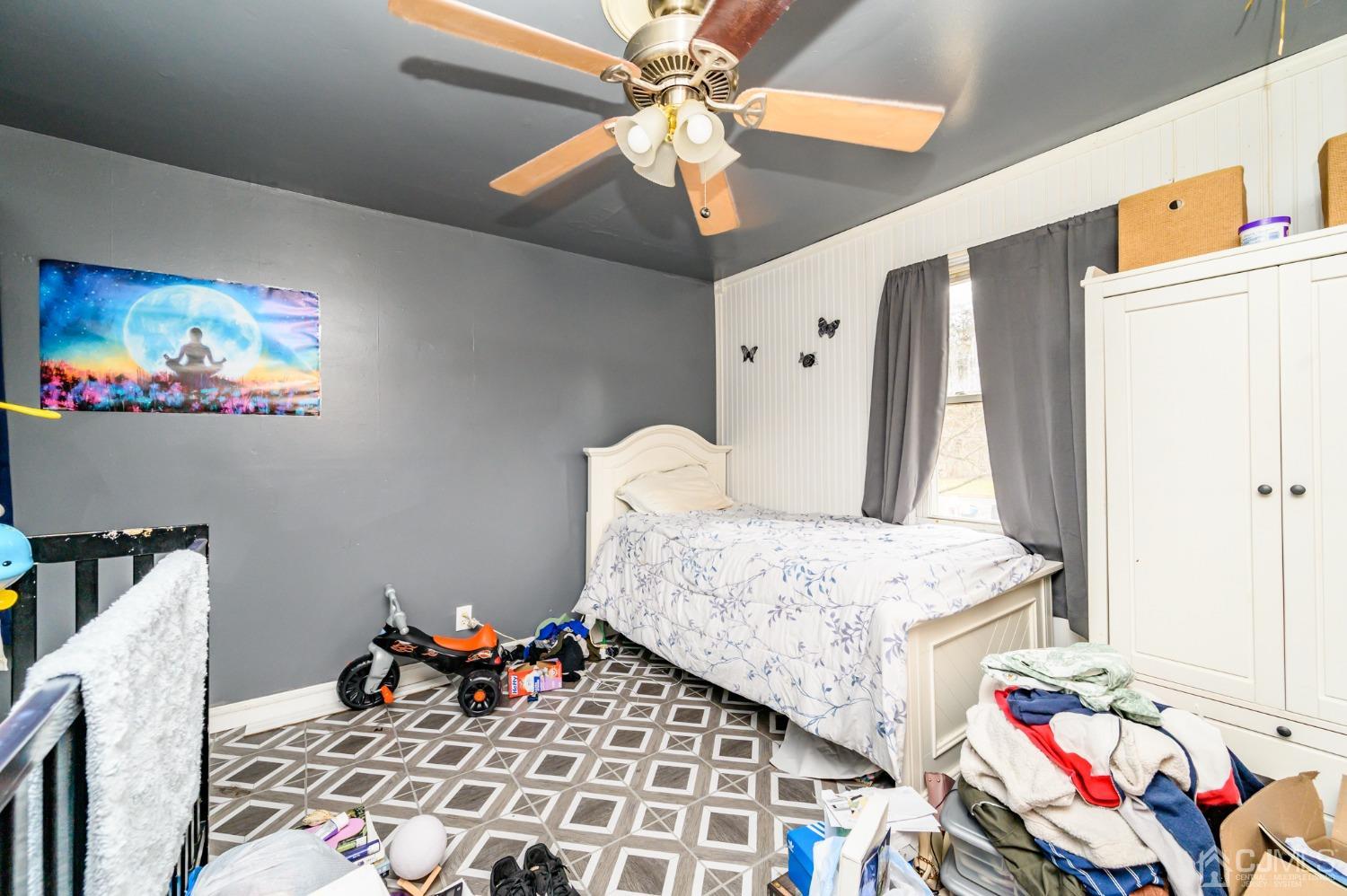 632 West Avenue Sewaren, NJ 07077 - Photo 11 of 30 a bedroom with a bed and a chandelier