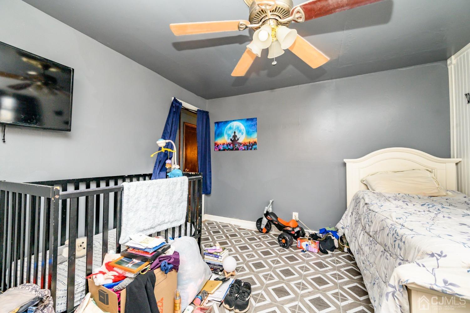 632 West Avenue Sewaren, NJ 07077 - Photo 12 of 30 a bedroom with a bed and wooden floor