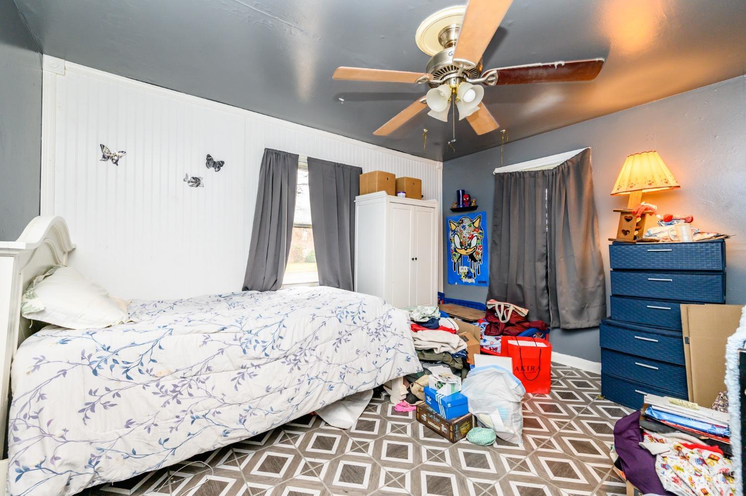 632 West Avenue Sewaren, NJ 07077 - Photo 13 of 30 a bedroom with a bed dresser and a chandelier