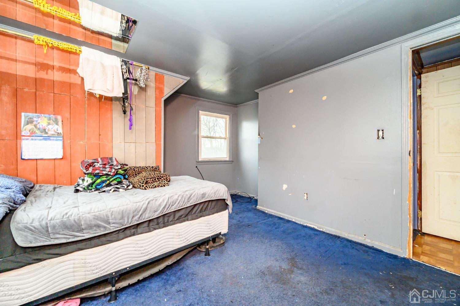 632 West Avenue Sewaren, NJ 07077 - Photo 18 of 30 a bedroom with a bed and window