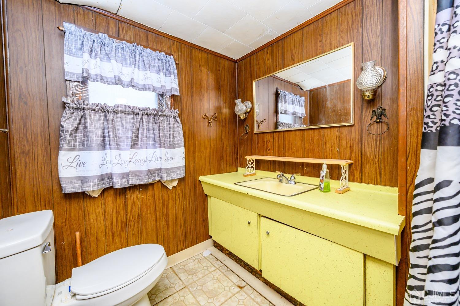 632 West Avenue Sewaren, NJ 07077 - Photo 21 of 30 a bathroom with a sink vanity mirror and toilet