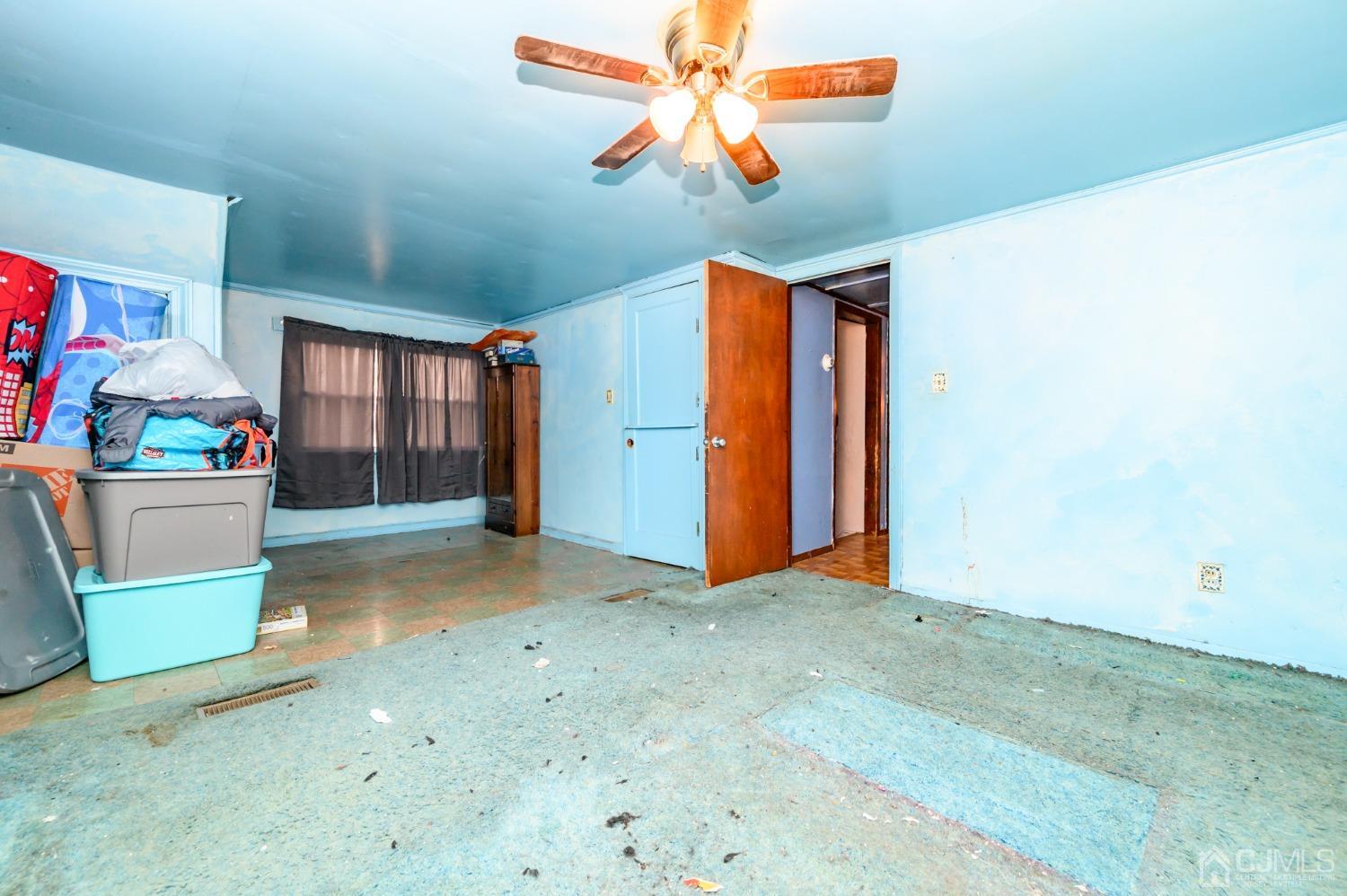 632 West Avenue Sewaren, NJ 07077 - Photo 23 of 30 a view of a livingroom with a chandelier fan and kitchen view