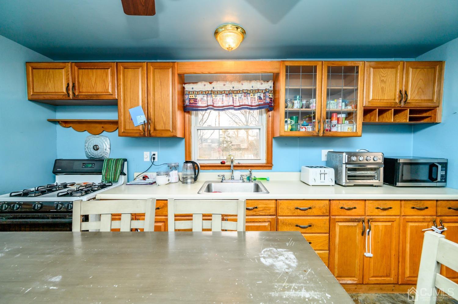 632 West Avenue Sewaren, NJ 07077 - Photo 8 of 30 a kitchen with stainless steel appliances kitchen island granite countertop a stove a sink and a microwave