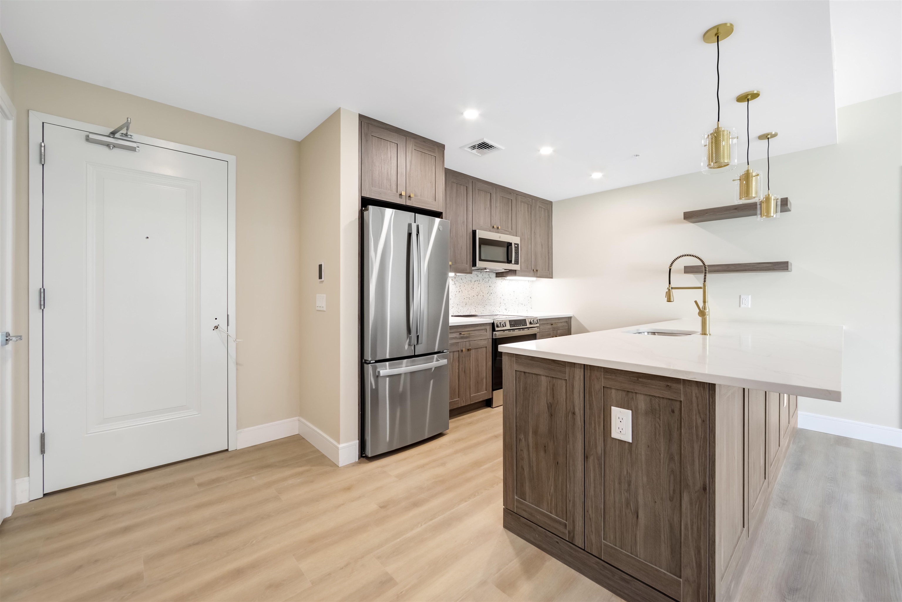 706 Madison Street, Unit 302 Hoboken, NJ 07030 - Photo 3 of 13 a kitchen with kitchen island a sink appliances and cabinets