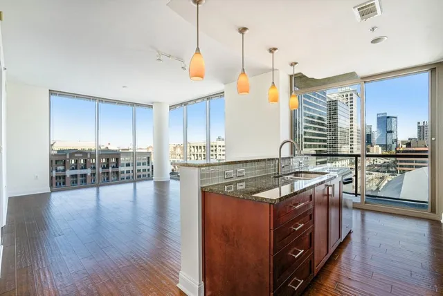 a kitchen with stainless steel appliances granite countertop a stove and a wooden floors