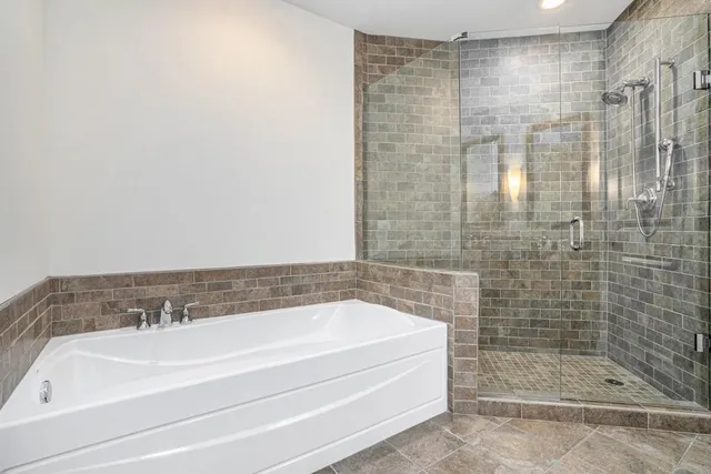 an empty room with balcony and a bathtub