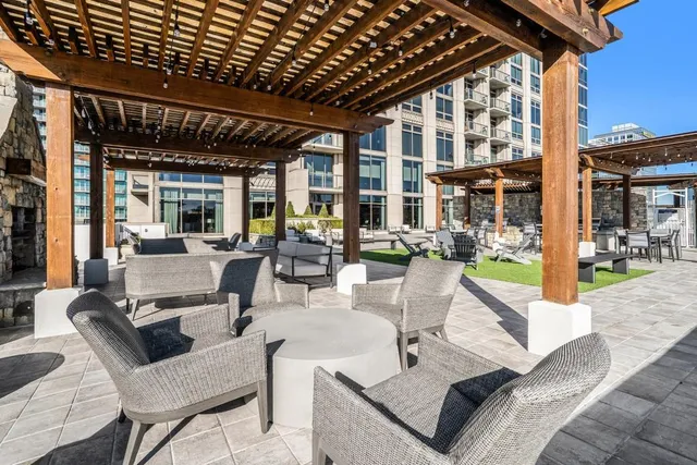 a living room with furniture wooden floor and a large window