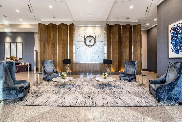 a spacious bedroom with a bed and a chandelier
