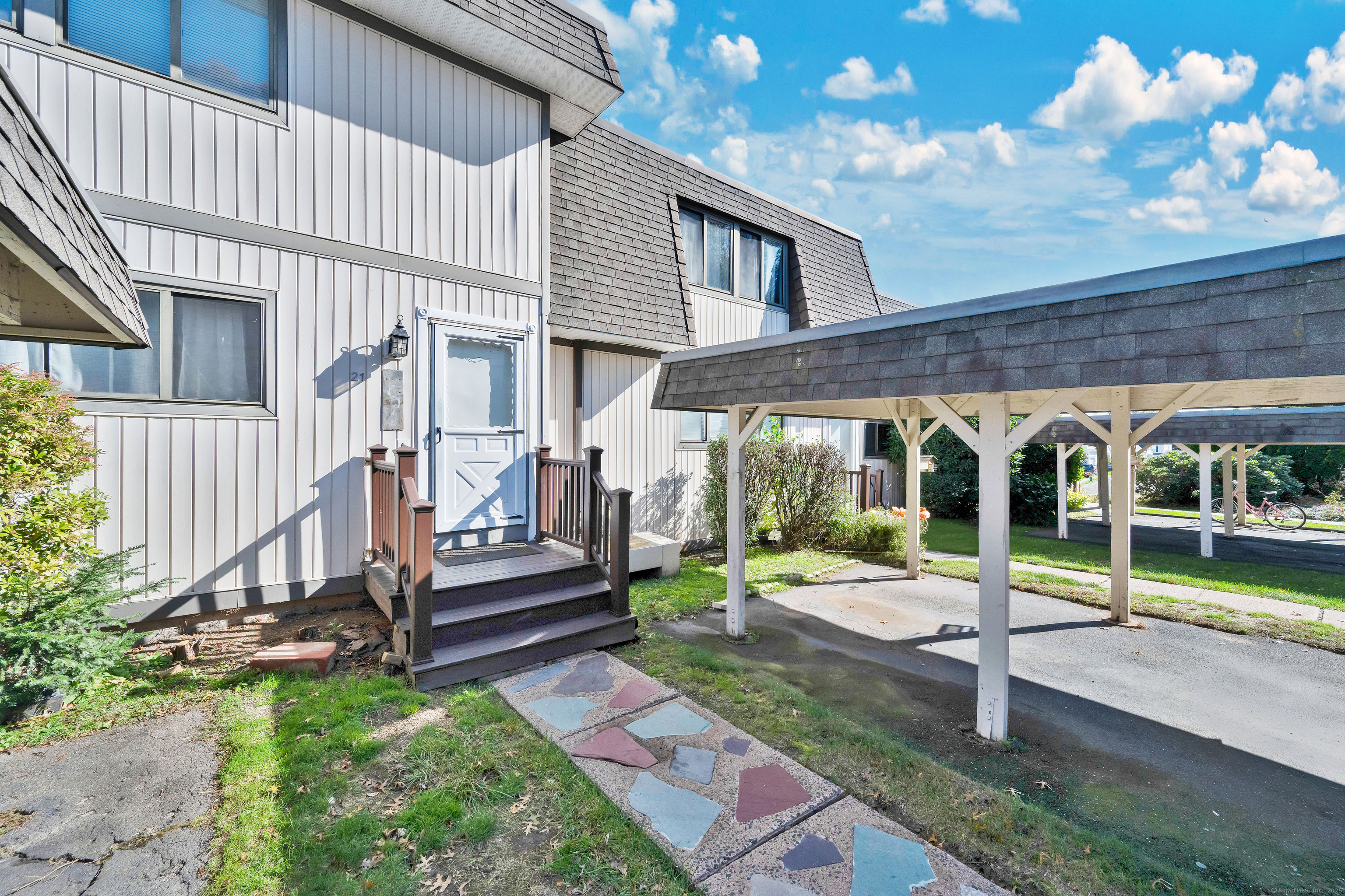 a view of a house with backyard and wooden deck