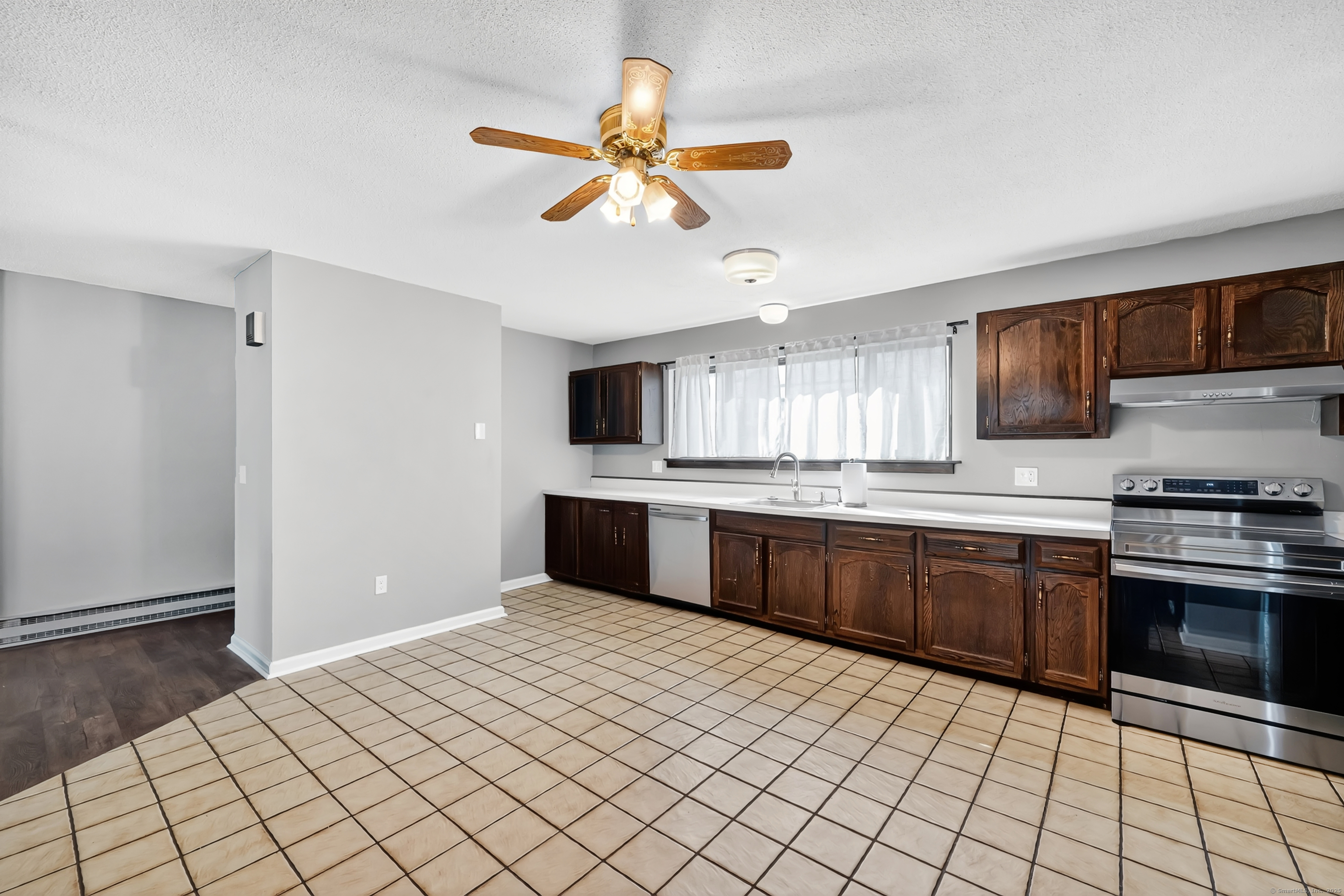 21 Pebblestone Circle, Unit 21 Suffield, CT 06078 - Photo 13 of 38 a kitchen with stainless steel appliances a sink cabinets and wooden floor