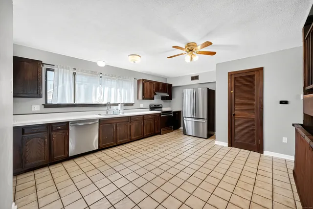 a kitchen with stainless steel appliances a sink and a refrigerator