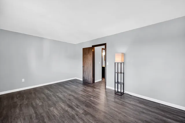 a view of wooden floor and windows in a room
