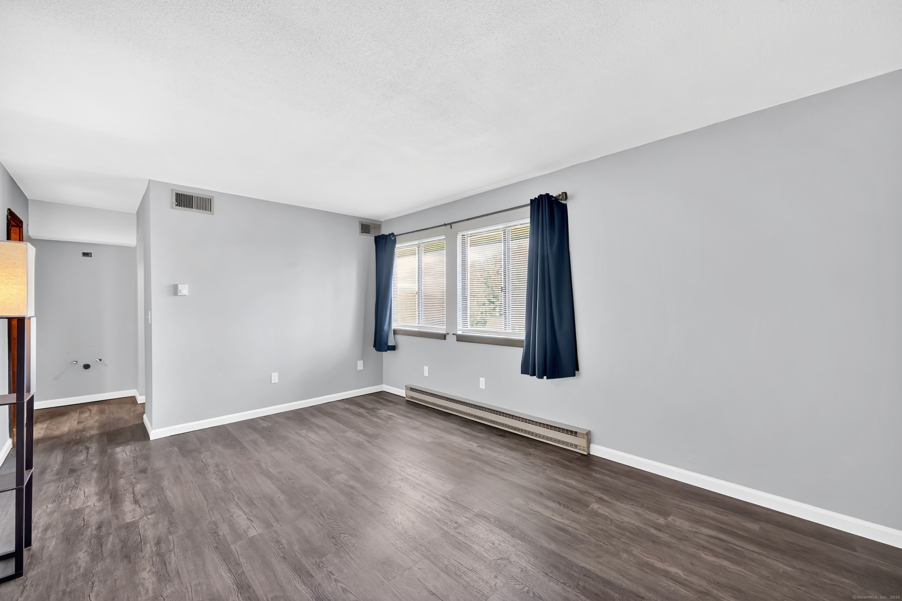 21 Pebblestone Circle, Unit 21 Suffield, CT 06078 - Photo 19 of 38 an empty room with wooden floor and windows