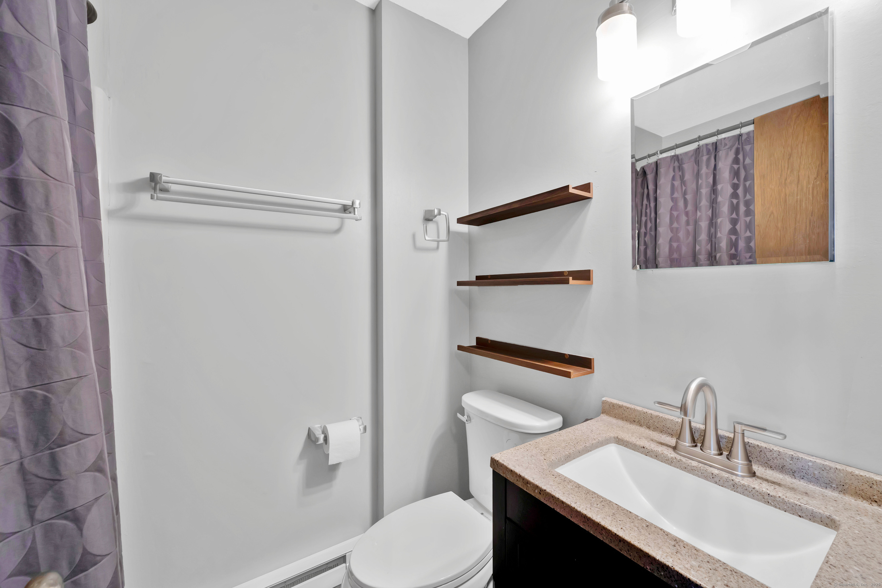 21 Pebblestone Circle, Unit 21 Suffield, CT 06078 - Photo 23 of 38 a bathroom with a sink vanity mirror and toilet