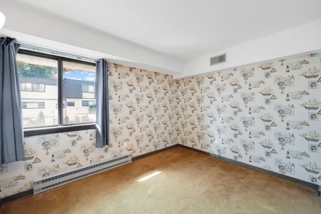 a view of a livingroom with wooden floor and a window
