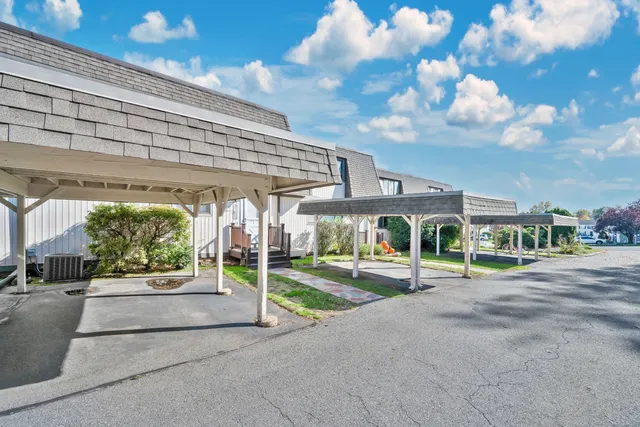 a view of a patio with table and chairs under an umbrella