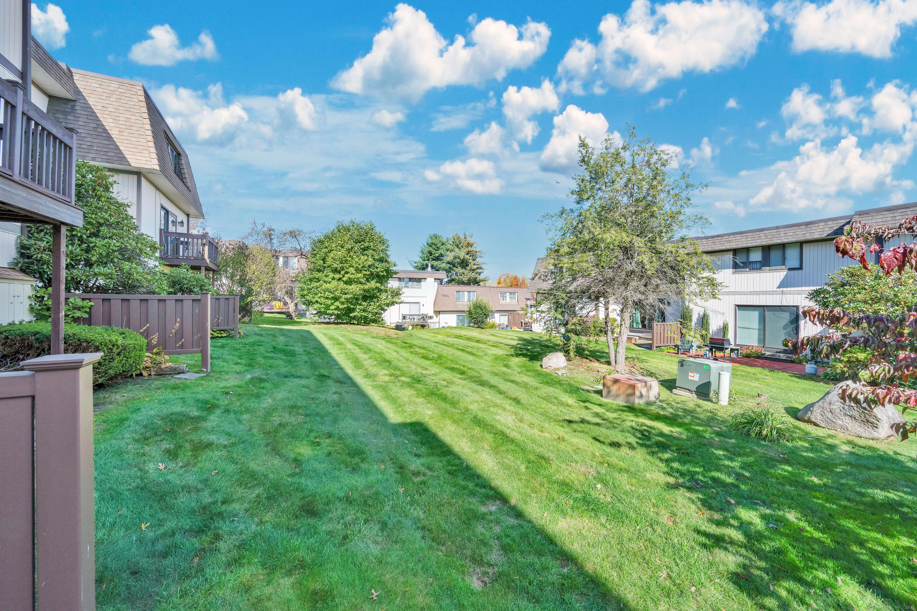 21 Pebblestone Circle, Unit 21 Suffield, CT 06078 - Photo 36 of 38 a view of a house with a big yard and potted plants