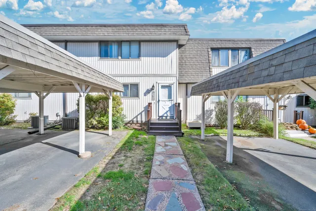 a view of a house with a porch and garden