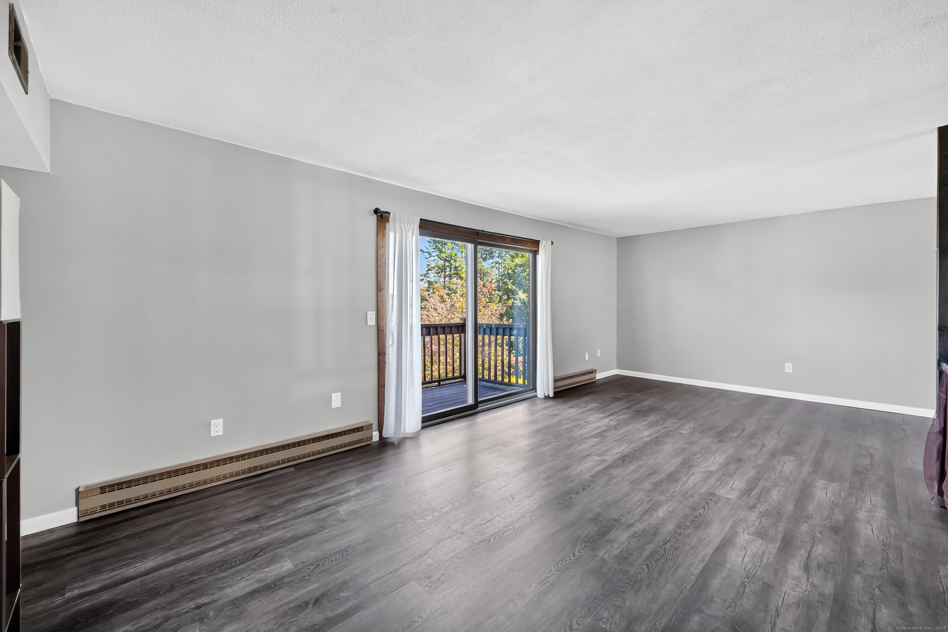 21 Pebblestone Circle, Unit 21 Suffield, CT 06078 - Photo 6 of 38 a view of an empty room with wooden floor and a window