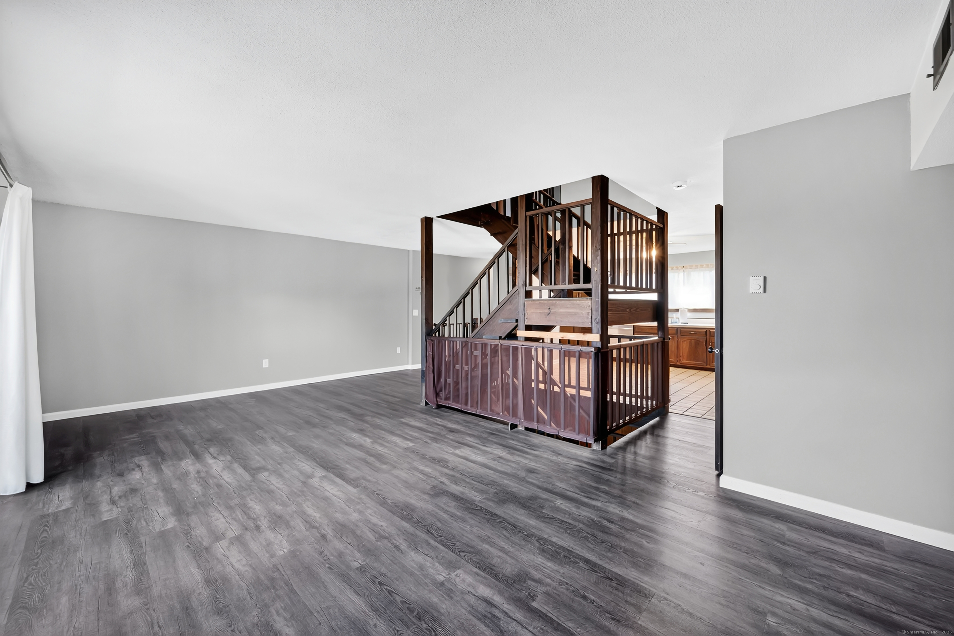 21 Pebblestone Circle, Unit 21 Suffield, CT 06078 - Photo 7 of 38 a view of a livingroom with wooden floor and stairs