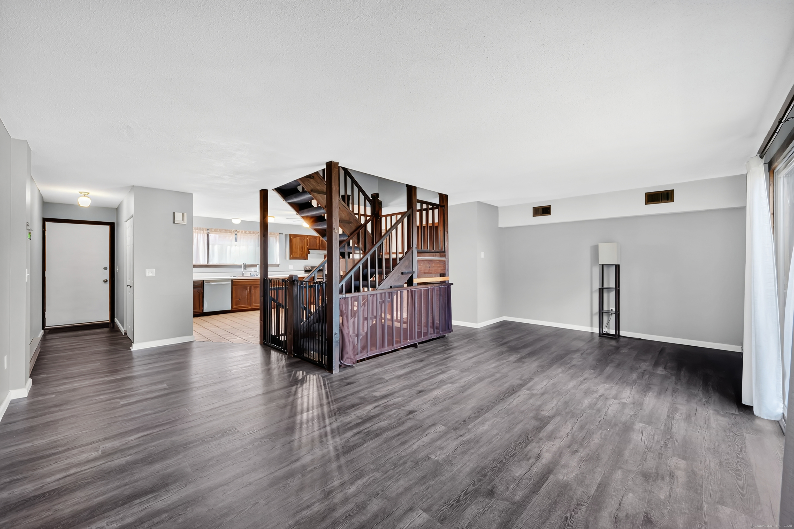 21 Pebblestone Circle, Unit 21 Suffield, CT 06078 - Photo 8 of 38 a view of an empty room with wooden floor and stairs