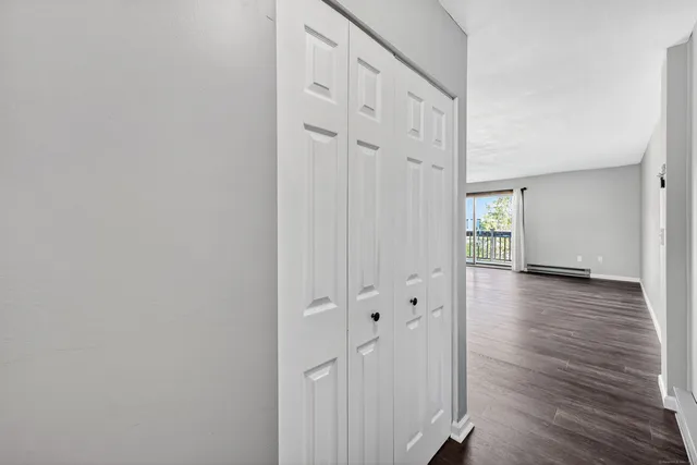 a view of a hallway with wooden floor