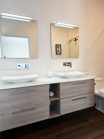 a bathroom with a sink double vanity and a mirror
