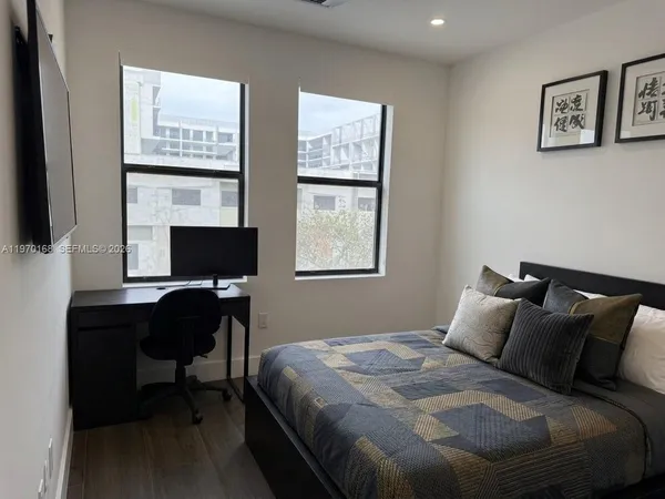 a bedroom with a bed and a desk