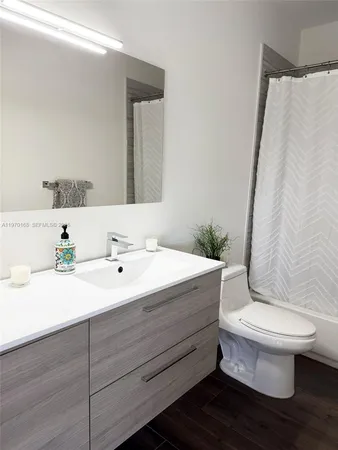 a bathroom with a sink toilet and mirror