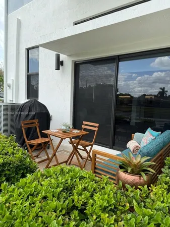 a backyard of a house with table and chairs