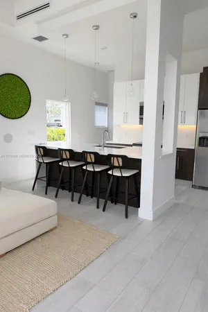 a large white kitchen with a large window