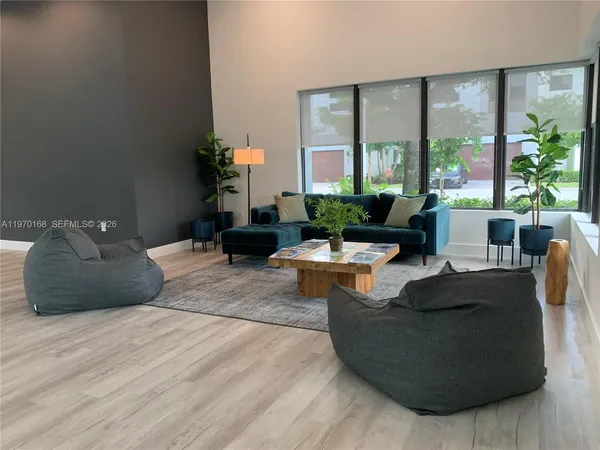 a living room with furniture and large windows