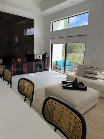 a bedroom with furniture and a large window