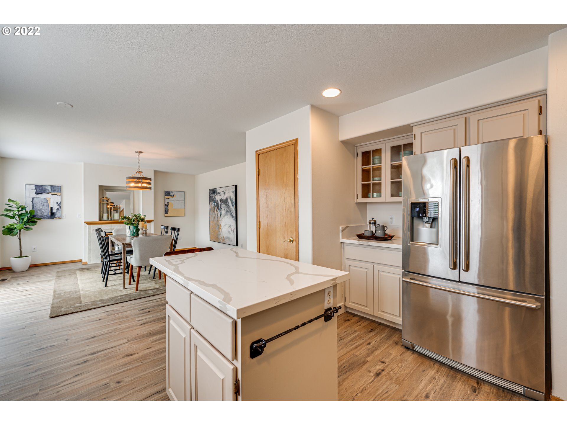 34 Depot Street Ridgefield, WA 98642 - Photo 8 of 32 a kitchen with a refrigerator a stove microwave and a dining table with wooden floor