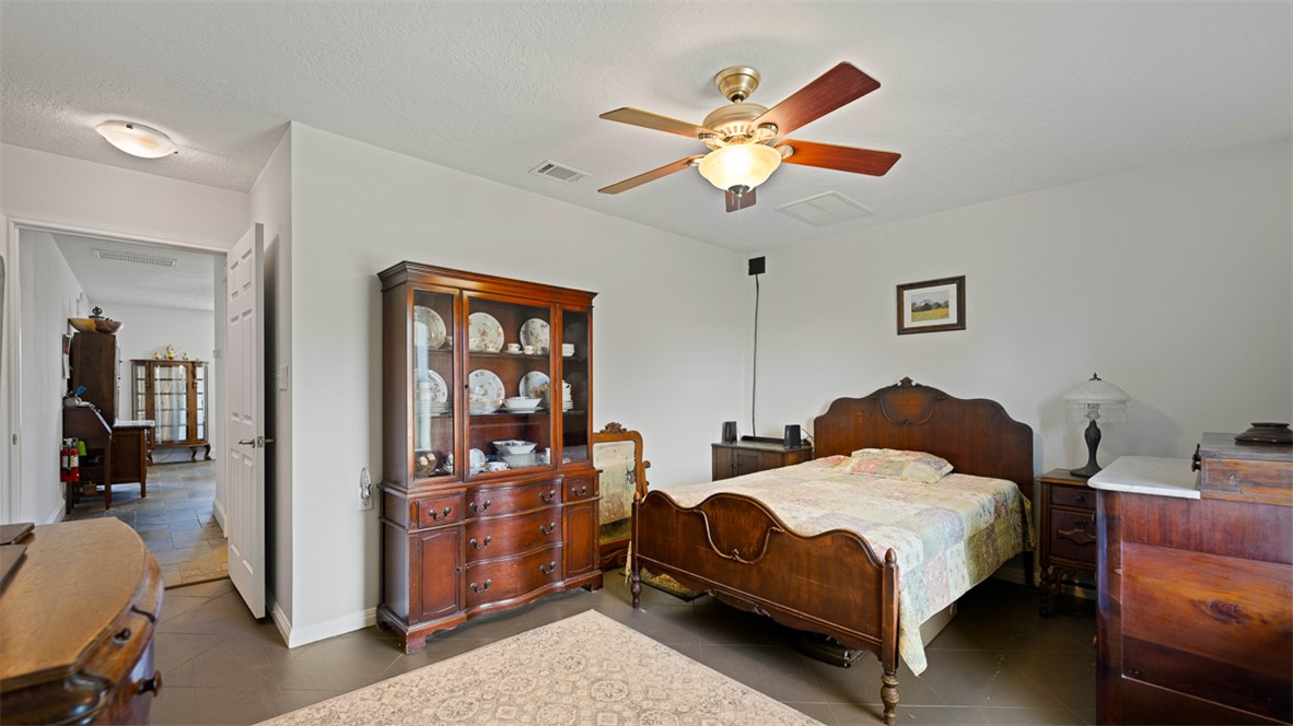 11258 Providence Road Hearne, TX 77859 - Photo 24 of 39 a bedroom with a bed and a chandelier
