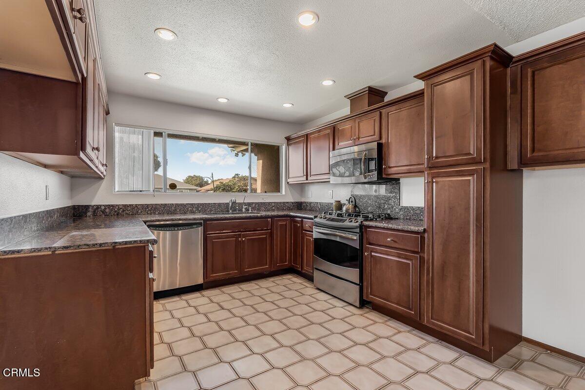 4800 Halsey Way Oxnard, CA 93033 - Photo 10 of 18 a kitchen with stainless steel appliances granite countertop a refrigerator stove and sink