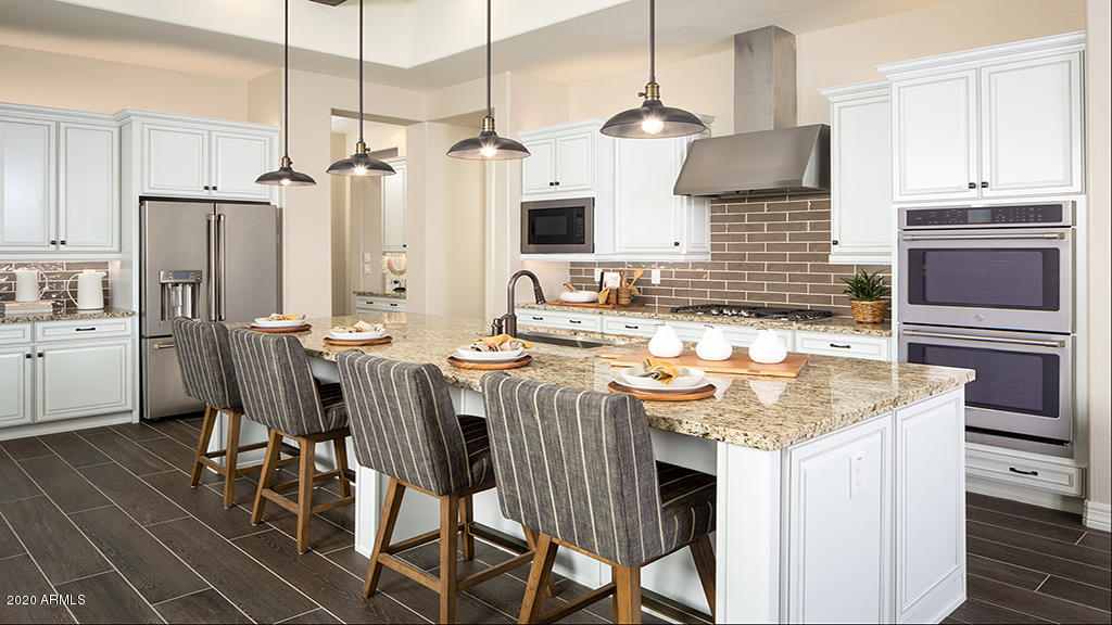 2046 East Trigger Way Gilbert, AZ 85297 - Photo 4 of 10 a kitchen with stainless steel appliances kitchen island granite countertop a sink and cabinets