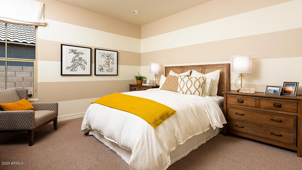 2046 East Trigger Way Gilbert, AZ 85297 - Photo 8 of 10 a bedroom with a bed and blue couch